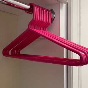 Pink plastic hangers from The Container Store